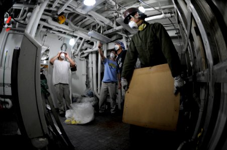 US Navy 090528-N-3830J-008 A member of the local ship repair facility team removes a mirror out of the 7th Fleet staff berthing spaces aboard the amphibious command ship USS Blue Ridge (LCC 19)
