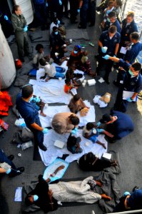 US Navy 090524-N-4774B-220 Somali migrants, including a nine-month pregnant female, are treated aboard the guided-missile cruiser USS Lake Champlain (CG 57), after being rescued from a disabled skiff