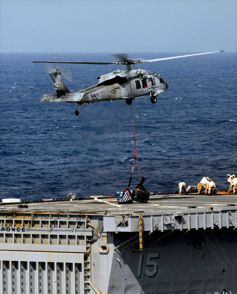 US Navy 090523-N-5345W-183 An MH-60S Sea Hawk helicopter assigned to the Sea Knights of Helicopter Combat Support Squadron (HSC) 22 delivers a load of stores to the flight deck of the amphibious transport dock ship USS Ponce (L
