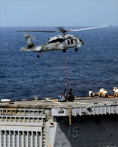 US Navy 090523-N-5345W-183 An MH-60S Sea Hawk helicopter assigned to the Sea Knights of Helicopter Combat Support Squadron (HSC) 22 delivers a load of stores to the flight deck of the amphibious transport dock ship USS Ponce (L