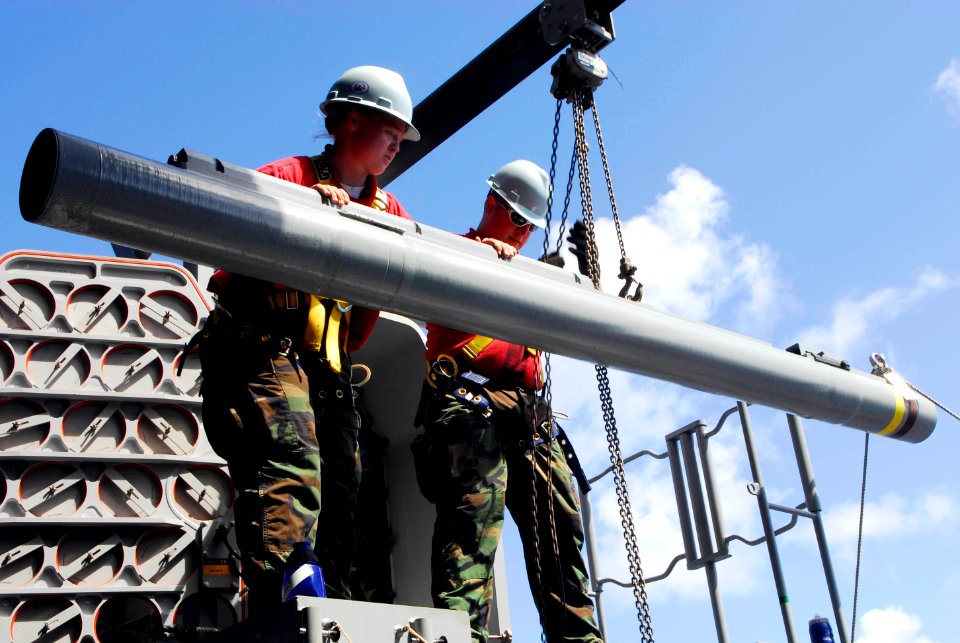 US Navy 090525-N-2475A-397 Fire Controlman 2nd Class Amber Hawkins, left, from Myrtle Creek, Ore., and Fire Controlman 2nd Class Warren Vaughn, from Albany, Ore., remove a RIM-116 Rolling Airframe Missile (RAM) from the forward