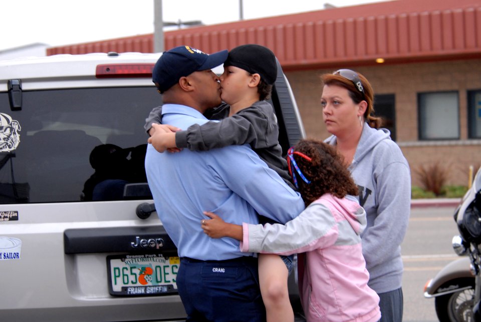 US Navy 090528-N-5586R-072 Hospital Corpsman 1st Class Nick Craig says goodbye to his wife and children on the pier before boarding the aircraft carrier USS Ronald Reagan (CVN 76)