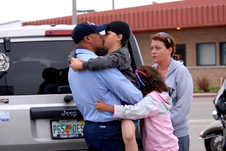 US Navy 090528-N-5586R-072 Hospital Corpsman 1st Class Nick Craig says goodbye to his wife and children on the pier before boarding the aircraft carrier USS Ronald Reagan (CVN 76)