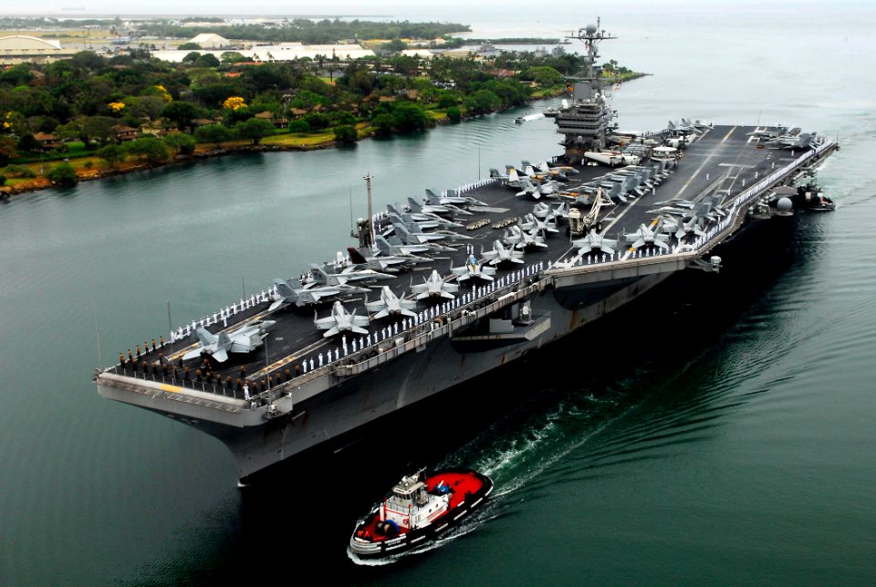 US Navy 090528-N-7780S-286 Sailors manning the rails aboard the aircraft carrier USS John C. Stennis (CVN 74) stand at parade rest prior to rendering hand salutes as the ship passes the USS Arizona Memorial