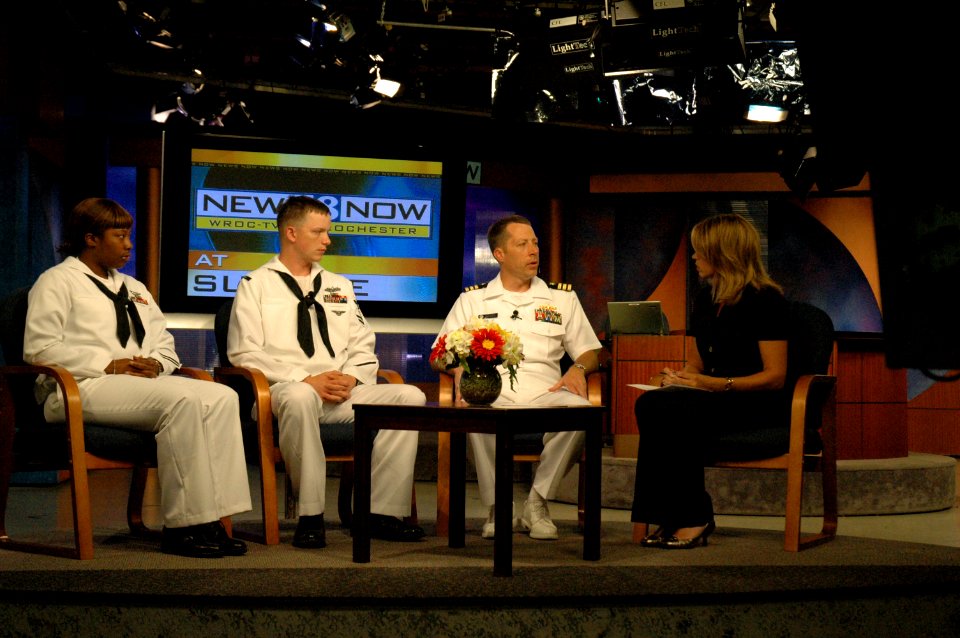 US Navy 090526-N-7975R-004 Cmdr. Curt Jones, commanding officer of Pre-Commissioning Unit (PCU) New York (LPD-21), Yeoman 2nd Class Mia Carney, and Operations Specialist 2nd Class Andrew Hahn answer questions during a live inte