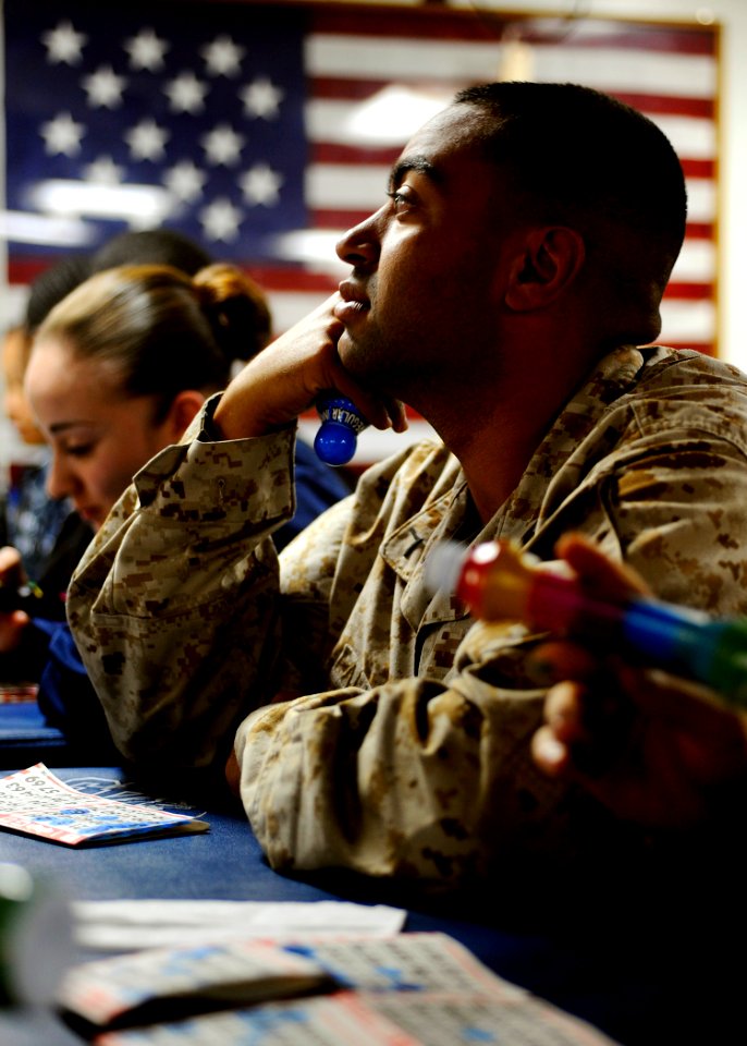 US Navy 090524-N-5345W-177 Pfc. Alonso Alvarado, assigned to the 22nd Marine Expeditionary Unit (22 MEU), waits for the next number to be called while participating in a Morale Welfare ^ Recreation (MWR) sponsored bingo night