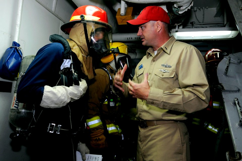US Navy 090527-N-7478G-112 Lt. j.g. Jeffrey Hanson, assistant damage control officer aboard the amphibious command ship USS Blue Ridge (LCC 19), instructs scene leader Hull Maintenance Technician 3rd Class Christopher Leddy