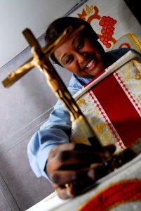 US Navy 090528-N-4053P-003 Seaman Aria Roberson, assigned to the Religious Ministries Department aboard the aircraft carrier USS Nimitz (CVN 68), prepares a Roman Catholic Mass