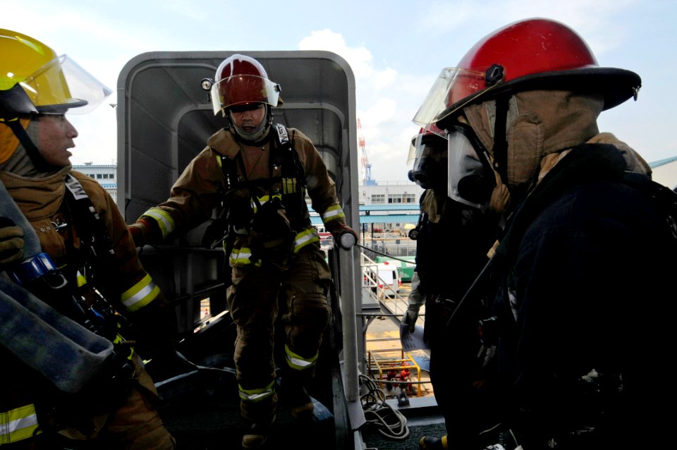 US Navy 090527-N-7478G-108 Sailors assigned to the amphibious command ship USS Blue Ridge conduct a fire drill with the Commander Fleet Activities Yokosuka Fire Department