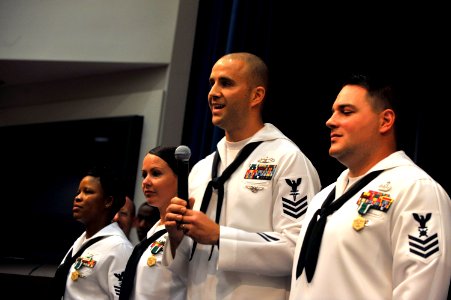 US Navy 090529-N-8273J-119 Hospital Corpsman 1st Class James Nicholson, middle, thanks his family and shipmates after being awarded Chief of Naval Operations Shore Activities Sailor of the Year