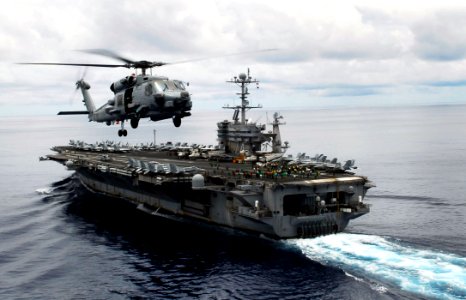 US Navy 090526-N-9928E-157 n MH-60R Sea Hawk helicopter from the Raptors of Helicopter Maritime Strike Squadron (HSM) 71 circles the aircraft carrier USS John C. Stennis (CVN 74) during flight operations