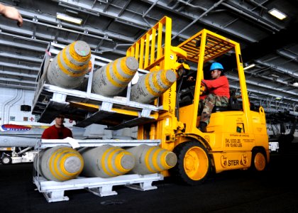 US Navy 090529-N-9988F-049 Aviation Ordnanceman 3rd Class Siobhan Smith drives a forklift during a weapons onload aboard the aircraft carrier USS Dwight D. Eisenhower (CVN 69)