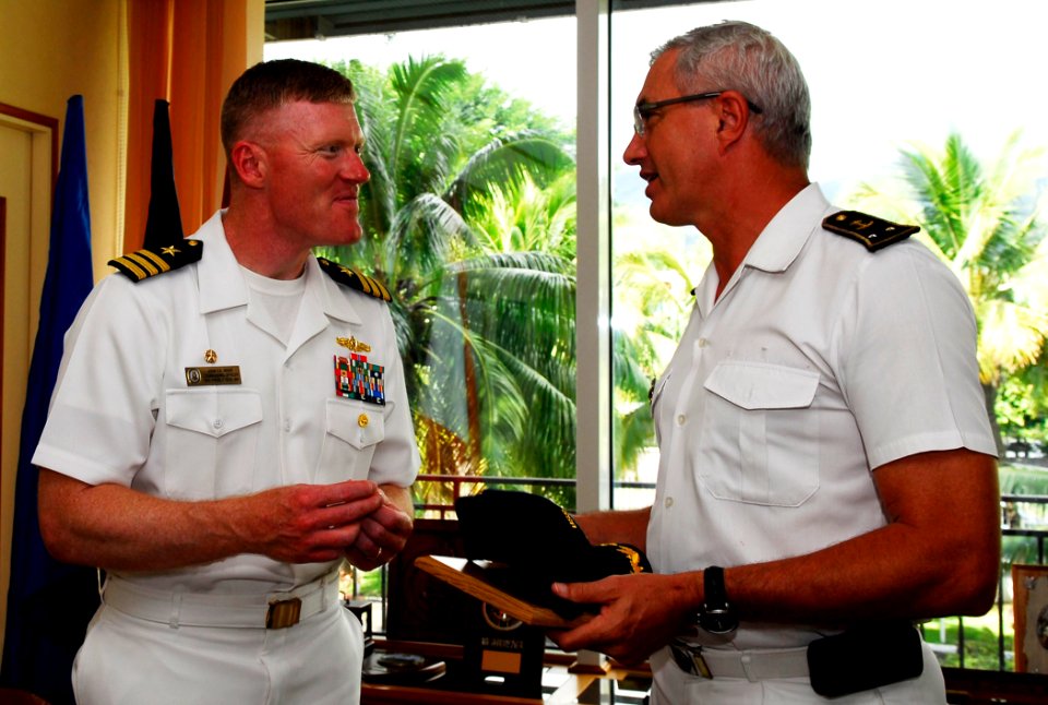 US Navy 090527-N-4047W-264 Cmdr. John Wade, commanding officer of the guided-missile destroyer USS Preble (DDG 88), left, exchanges gifts with Rear Adm. Jean Louis Vichot