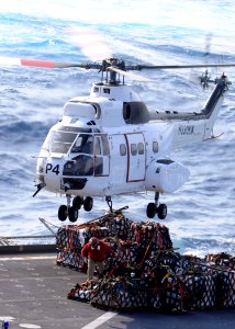 US Navy 090529-N-1062H-033 An SA-330 Puma helicopter retrieves cargo for transfer to the guided-missile cruiser USS Cowpens (CG 63)