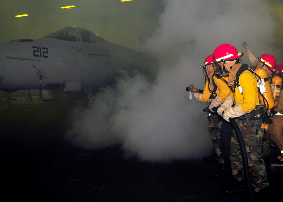US Navy 090528-N-6233C-010 ailors assigned to the Air department, V3 division aboard the aircraft carrier USS George Washington (CVN 73) fight a simulated hangar bay aircraft fire during a general quarters drill