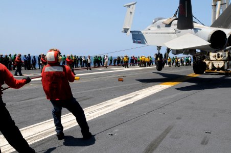 US Navy 090601-N-2344B-207 Aviation Boatswain's Mate (Handling) Airman Alejandro Lopez, from Phoenix, controls the movement of a crash and salvage training jet during a flight deck drill