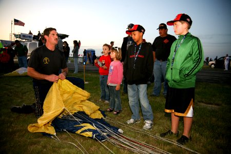 US Navy 090529-N-3271W-258 Chief Petty Officer William Davis speaks with fans after performing a jump with the U.S. Navy demonstration parachute team, the Leap Frogs, at the Southern Wisconsin Airfest photo