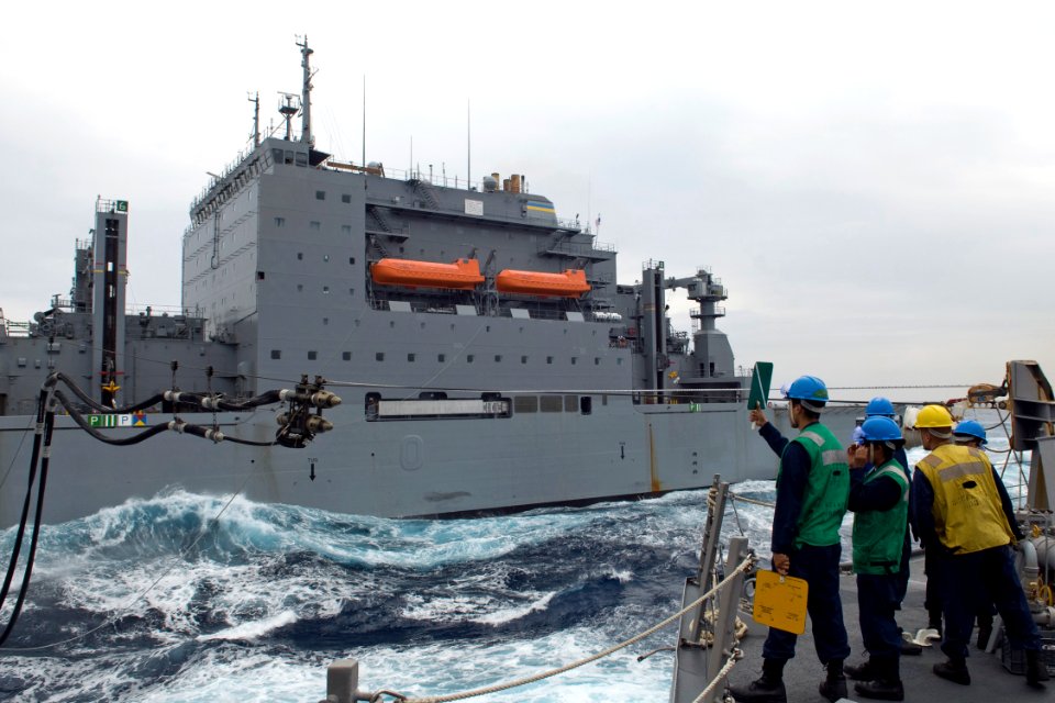 US Navy 090529-N-9123L-131 The refueling detail aboard the guided-missile destroyer USS McCampbell (DDG 85) guides a probe from the Military Sealift Command fleet replenishment oiler USNS Richard E. Byrd (T-AKE 4)