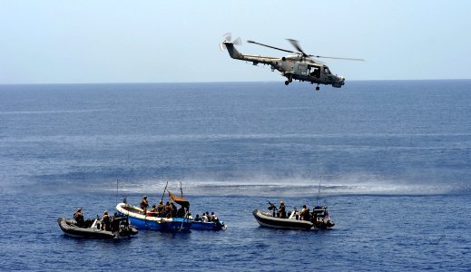 US Navy 090602-N-0000X-001 Royal Marines embarked aboard the Royal Navy frigate HMS Portland (F 79) investigate two suspected pirate skiffs in the Gulf of Aden