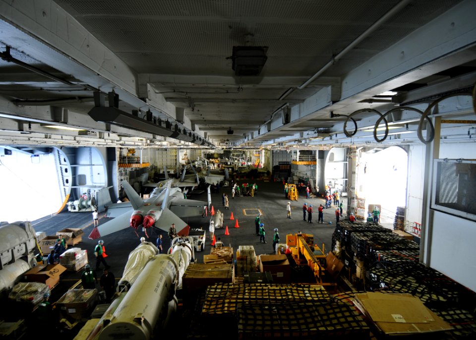 US Navy 090529-N-1062H-042 Supply and deck department Sailors transfer cargo in the hangar bay of the aircraft carrier USS George Washington (CVN 73) during a replenishment-at-sea