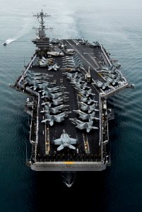 US Navy 090528-N-7780S-161 Sailors manning the rails on the flight deck of the aircraft carrier USS John C. Stennis (CVN 74) stand at parade rest before rendering hand salutes as the ship passes the USS Arizona Memorial