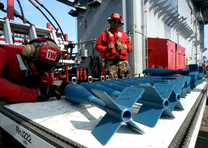 US Navy 090529-N-6720T-250 Aviation Ordnanceman 2nd Class Pablo Paredes prepares MK-76 inert bombs aboard the aircraft carrier USS George Washington (CVN 73)