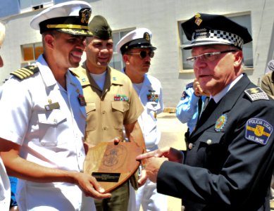 US Navy 090529-N-9740S-273 apt. Sam Howard, commanding officer of the multi-purpose amphibious assault ship USS Bataan (LHD 5), presents Palma De Mallorca Police Chief Nicolas Herrero with a plaque photo