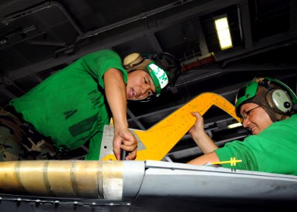 US Navy 090530-N-1062H-168 Aviation Structural Mechanic 2nd Class Melvin Go and Aviation Structural Mechanic 1st Class Ritchie Abuda adjust the speed brake on an EA-6B Prowler