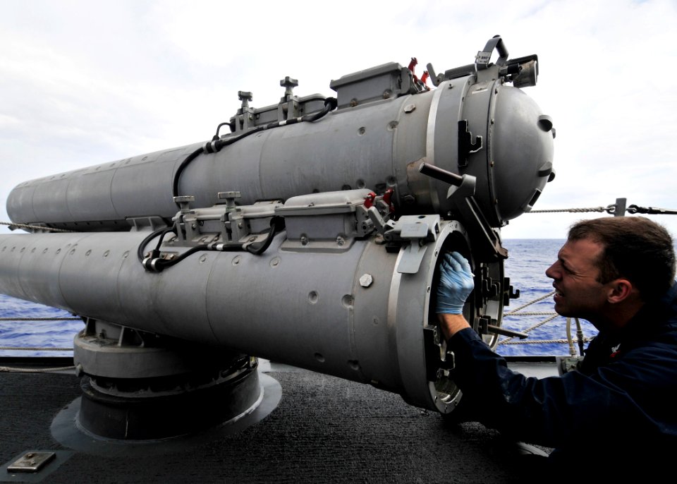 US Navy 090529-N-2638R-002 Gunner's Mate 2nd Class Justin Headley, from Vashon, Wash., conducts preventative maintenance on a MK 32 surface vessel torpedo tube aboard the Arleigh Burke-class guided-missile destroyer USS Mustin