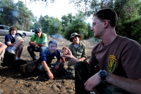 US Navy 090530-N-2959L-310 A U.S. Navy Survival, Evasion, Resistance and Escape (SERE) instructor lights a storm proof match for members of Boy Scout Troop 806 of Coronado, Calif. to demonstrate how the match can still burn aft