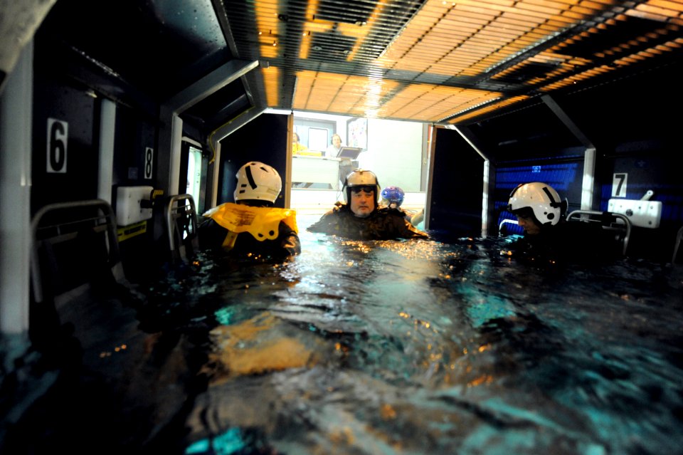 US Navy 090604-N-0413R-053 Students strap into the 9D6B Modular Egress Training System (METS) before they are elevated and dropped back into the pool to simulate a helicopter crash at the Aviation Survival Training Center in Ja