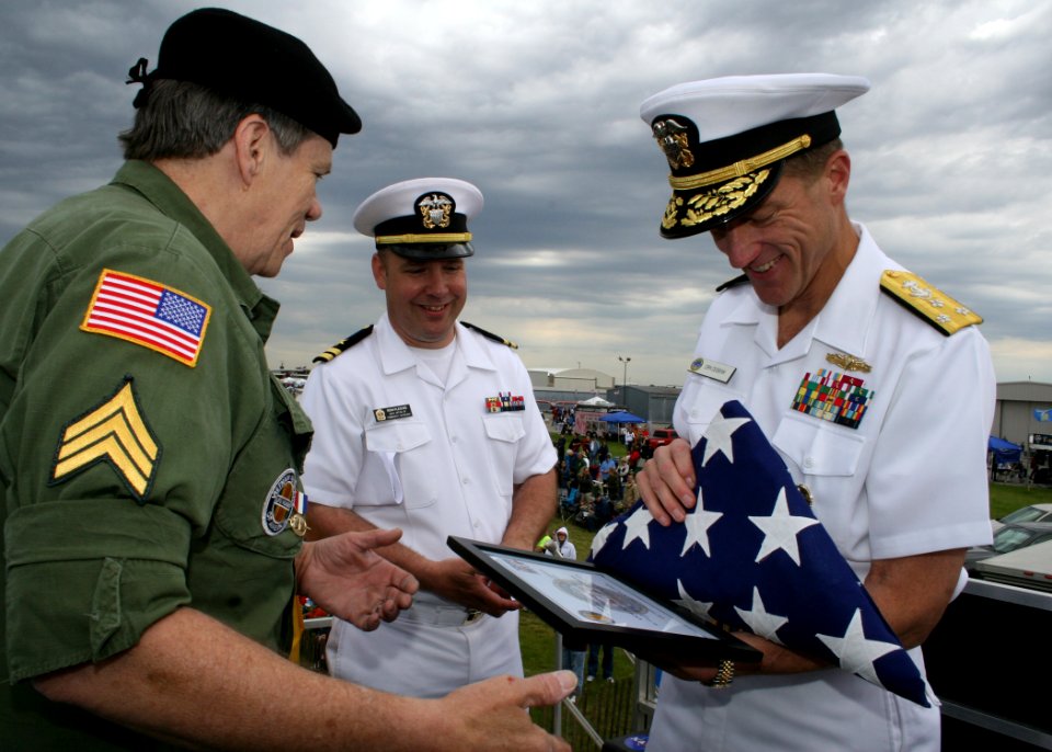 US Navy 090530-N-5366K-012 Bob Engstrom, left, presents a flag to Vice Adm. Dirk Debbink, Chief of Navy Reserve, to honor POW-MIAs at the remembrance table ceremony during the Southern Wisconsin AirFest 2009