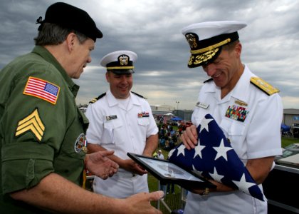 US Navy 090530-N-5366K-012 Bob Engstrom, left, presents a flag to Vice Adm. Dirk Debbink, Chief of Navy Reserve, to honor POW-MIAs at the remembrance table ceremony during the Southern Wisconsin AirFest 2009 photo