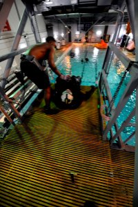 US Navy 090604-N-0413R-096 Students are hoisted to a platform at the Aviation Survival Training Center in Jacksonville, Fla. where they will strap into a parachute harness and practice releasing themselves into the pool