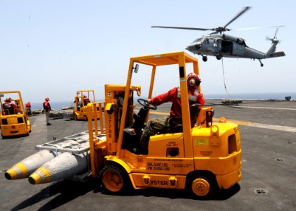 US Navy 090529-N-9988F-092 Aviation Ordnanceman 3rd Class Natasha Colon drives a forklift on the flight deck of the aircraft carrier USS Dwight D. Eisenhower (CVN 69) during a weapons onload