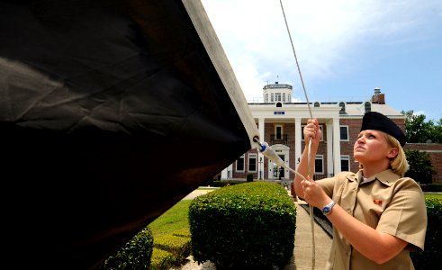 US Navy 090604-N-5328N-086 Cryptologic Technician (Interpretive) Seaman Shannon Parmley, a student at the Center for Information Dominance Corry Station, raises the black flag for the first time in 2009 photo