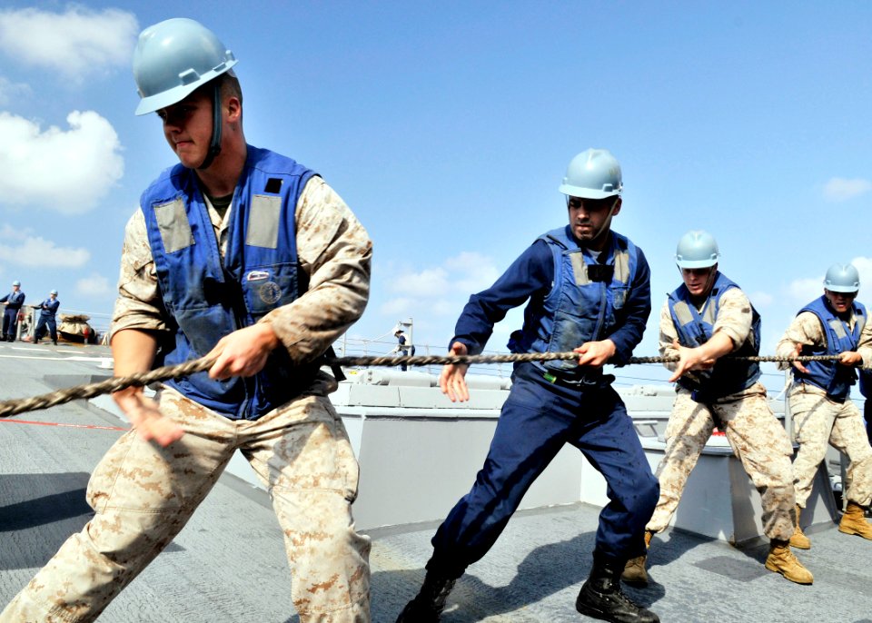 US Navy 090530-N-2638R-002 ailors aboard the Arleigh Burke-class guided-missile destroyer USS Mustin (DDG 89) and Marines assigned to the Fleet Anti-Terrorism Security Team Pacific heave a line