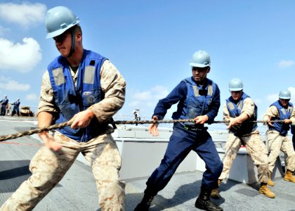 US Navy 090530-N-2638R-002 ailors aboard the Arleigh Burke-class guided-missile destroyer USS Mustin (DDG 89) and Marines assigned to the Fleet Anti-Terrorism Security Team Pacific heave a line