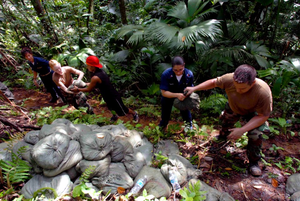 US Navy 090602-N-6259S-211 Service members embarked aboard the Military Sealift Command hospital ship USNS Comfort (T-AH 20) carry bags of rocks a half mile into the rainforest in the Colon province of Panama