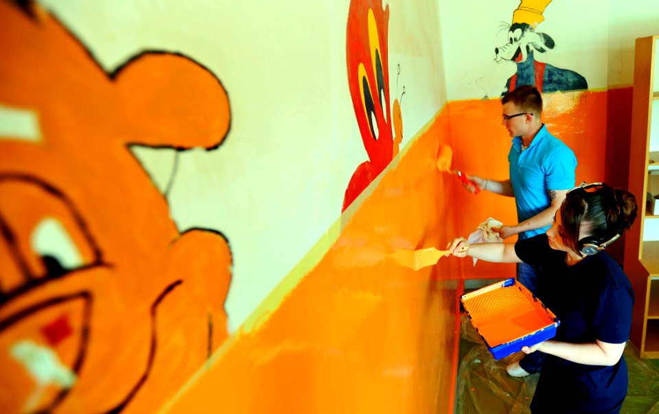 US Navy 090601-N-5345W-028 Ship's Serviceman Seaman Timothy Roberts and Ship's Serviceman 3rd Class Virginia Karbasi paint dormitory walls at the Fra Ante Sekelez Center for Rehabilitation