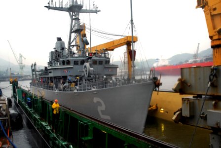 US Navy 090603-N-0807W-095 The mine warfare ship USS Defender (MCM 2) enters the submerged deck of the Military Sealift Command heavy-lift vessel Condock IV during a float-on-float-off evolution in Sasebo basin