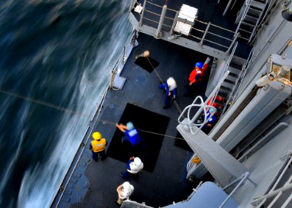 US Navy 090606-N-4774B-542 Sailors aboard the guided-missile cruiser USS Lake Champlain (CG 57) heave a line from the Military Sealift Command fleet replenishment oiler USNS Big Horn (T-AO 198)