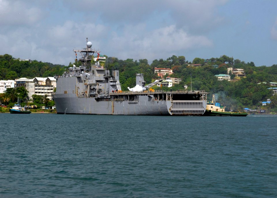 US Navy 090609-N-0924R-075 A tugboat helps turn USS Oak Hill (LSD 51), around in the bay before mooring pier side