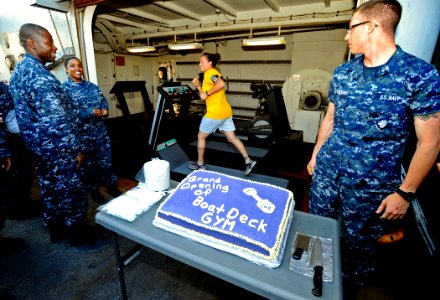 US Navy 090604-N-5345W-015 Damage Controlman 2nd Class Tiffany Stevens takes a test run on one of the treadmills in the new boat-deck gym during a ribbon and cake cutting ceremony