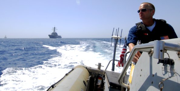 US Navy 090607-N-6639M-039 Boatswain's Mate 2nd Class Andrew Hymans operates a rigid hull inflatable boat