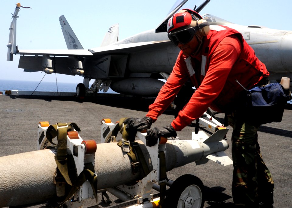 US Navy 090606-N-9988F-933 Aviation Ordnanceman 2nd Class Jose Hernandez moves ordnance on the flight deck