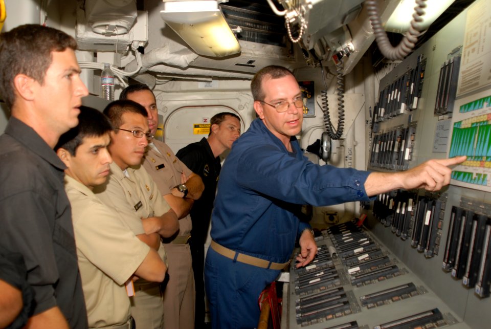 US Navy 090605-N-0924R-010 Chief Hull Technician Scott Whitman gives liaison naval officers from Uruguay