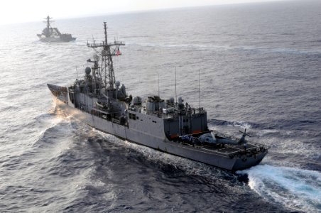 US Navy 090606-N-1635S-195 The guided-missile frigate USS Thach (FFG 43) steams toward the setting sun after concluding a burial at sea ceremony