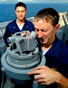 US Navy 090605-N-5345W-134 Midshipmen 2nd Class Alex Guffey, an NROTC student at Auburn University, receives instructions from Lt. j.g. Jonathan Pastell on how to take a bearing reading