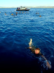 US Navy 090606-N-5345W-119 A Marine assigned to the 22nd Marine Expeditionary Unit (22 MEU) swims towards the stern gate of the amphibious dock landing ship USS Fort McHenry (LSD 43) as Sailors and Marines enjoy a swim call